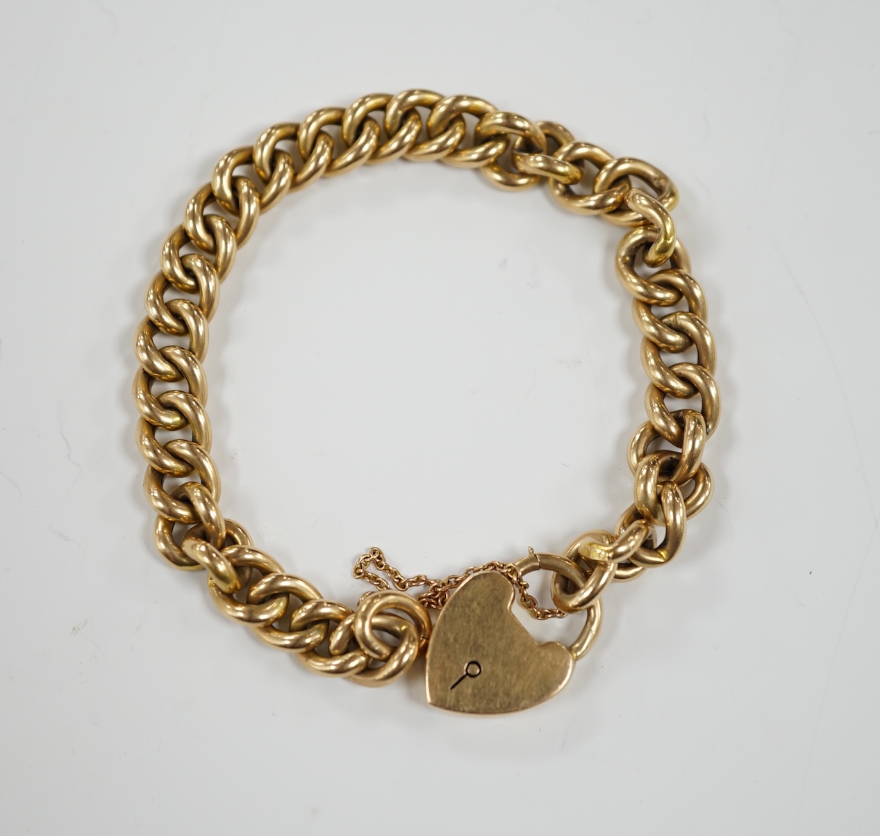 An Edwardian 15ct gold curb link bracelet, with heart shaped padlock clasp, 20cm